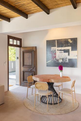 a dining room with a wooden table and chairs at Chariclea Villas Retreat in Samos
