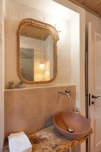 a bathroom with a sink and a mirror at Chariclea Villas Retreat in Samos