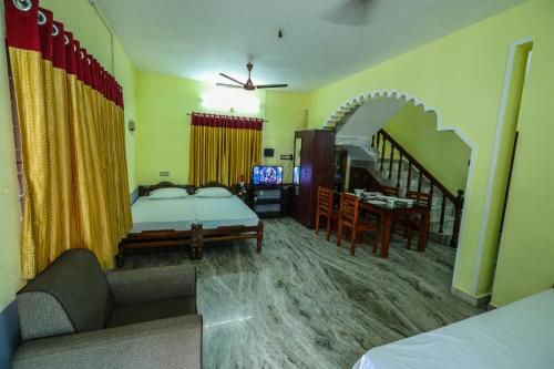 a living room with a bed and a staircase at Parkhil Homes in Cochin