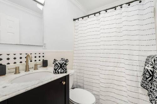a bathroom with a sink and a shower curtain at Lovely 2-Bdr w/Patio, Lake Park! in Naples