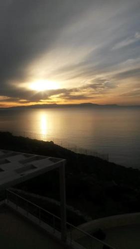 a sunset over the water with the sun in the sky at Seascape in Tersanas
