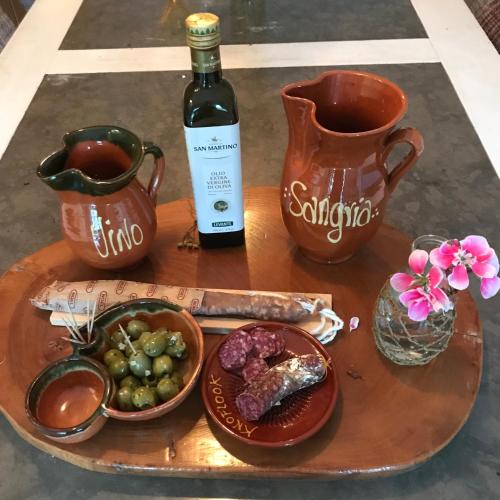a table with a bottle of wine and a plate of food at Great House for Two in Amsterdam in Amsterdam
