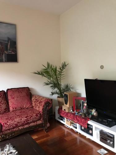 a living room with a couch and a flat screen tv at Great House for Two in Amsterdam in Amsterdam