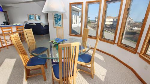 a kitchen and dining room with a glass table and chairs at Semi-Oceanfront, Private Pool, Hot Tub, Close to Beach Access, GF2, Touch of Grey in Sanderling