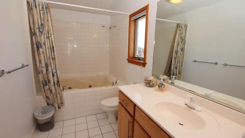 a bathroom with a sink and a toilet and a tub at Semi-Oceanfront, Private Pool, Hot Tub, Close to Beach Access, GF2, Touch of Grey in Sanderling