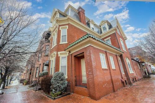 a large red brick house with a porch at Stylish Private 2 Bed Apt in Harrisburg