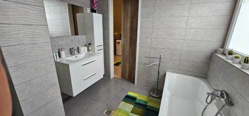 a bathroom with a white sink and a toilet at Boldogfalvi apartman in Debrecen