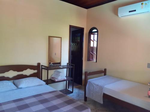 Ένα ή περισσότερα κρεβάτια σε δωμάτιο στο Pousada Paraíso do Mundo