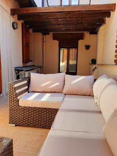 a living room with a couch with pillows on it at La Cabaña de Llívia, Cerdanya, Puigcerdà. in Llivia