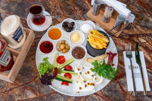 a plate of food with vegetables and other foods on a table at Armoni Deluxe Suites Trabzon in Trabzon