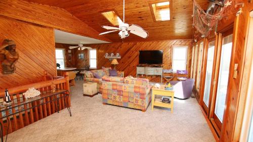 a living room with a couch and a ceiling fan at Oceanside, Friday to Friday, Sun Decks, Close to shopping, KD22, Summer Reflections in Kill Devil Hills
