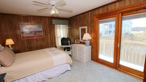 a bedroom with a bed and a ceiling fan at Oceanside, Friday to Friday, Sun Decks, Close to shopping, KD22, Summer Reflections in Kill Devil Hills