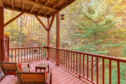 a screened porch with two chairs and a table at Quiet Murphy Hideaway with Decks and Outdoor Fireplace in Murphy