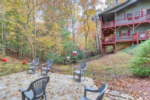a group of chairs sitting outside of a house at Quiet Murphy Hideaway with Decks and Outdoor Fireplace in Murphy