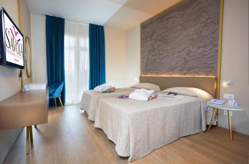 Ένα ή περισσότερα κρεβάτια σε δωμάτιο στο Hotel Savoia Thermae & SPA