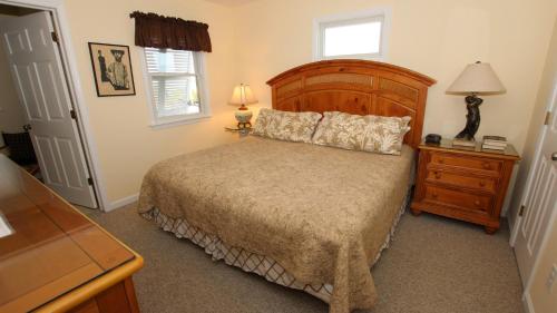 a bedroom with a bed and a dresser and a window at OCEANFRONT, Ocean Views, Private Beach Access, Sun Decks, KD229, The Sand Trap in Kill Devil Hills