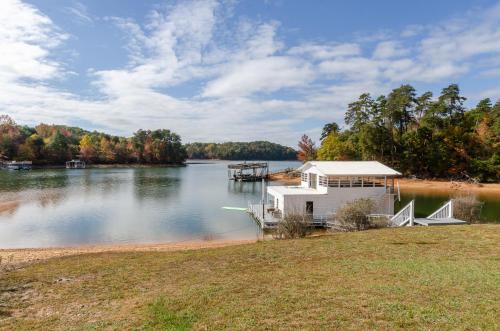 a small house on a lake with a dock at Lakeside Haven in Gainesville