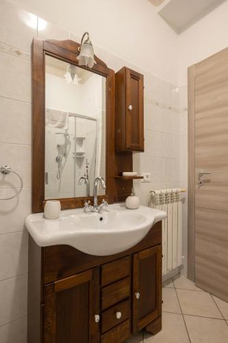 a bathroom with a sink and a mirror at Appartamenti - Here&Now in front of The Castle in Tresana