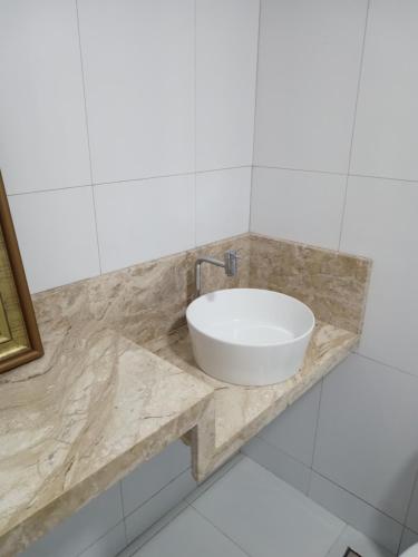 a white sink on a marble counter in a bathroom at PRIME HOSPEDAGENS - Residencial Bellágio in São Luís