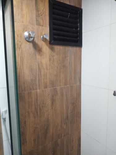 a shower with a wooden floor and a vent at PRIME HOSPEDAGENS - Residencial Bellágio in São Luís