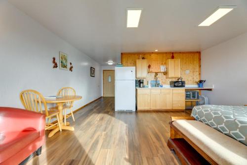 a room with a kitchen and a table and a refrigerator at Sanderling Sea Cottages, Unit 14 in Waldport