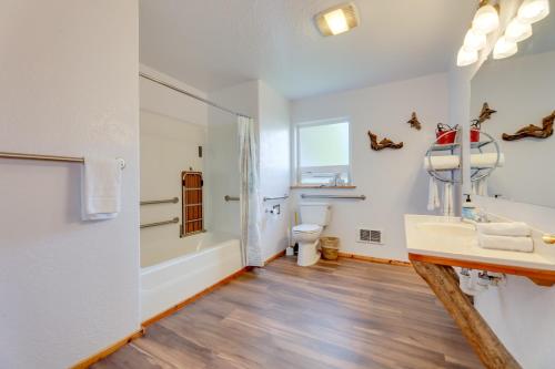 a bathroom with a sink and a tub and a toilet at Sanderling Sea Cottages, Unit 14 in Waldport