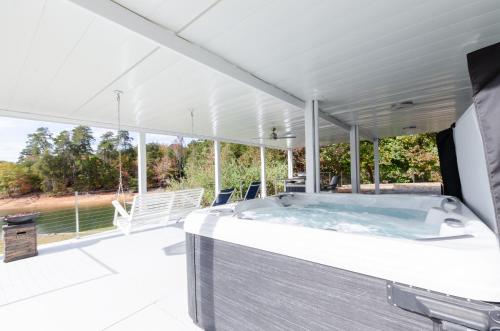 a hot tub on the deck of a house at Lakeside Haven in Gainesville