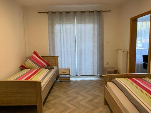 a bedroom with two beds and a window at Apartment Natali in Schnaittenbach