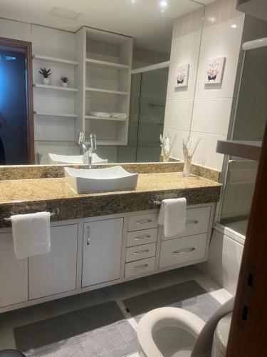 a bathroom with a sink and a toilet at Tropical executive in Manaus