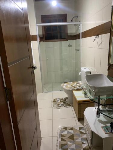 y baño con ducha, lavabo y aseo. en 3 Pinheiros en Campos do Jordão