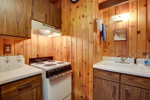 a kitchen with a stove and a sink at Buckhorn in Iron River with Sauna Fish and Hike! in Iron River