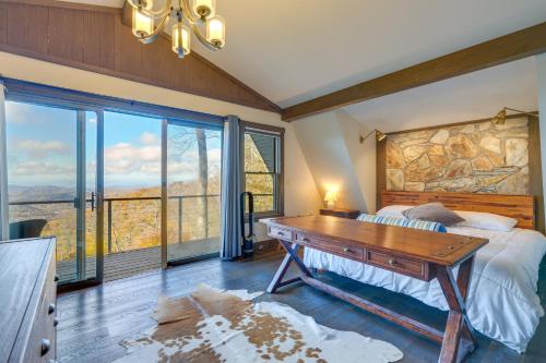 Schlafzimmer mit einem Bett und einem Holzschreibtisch in der Unterkunft Wolf Laurel Resort Home with Long Range Views! in Swiss