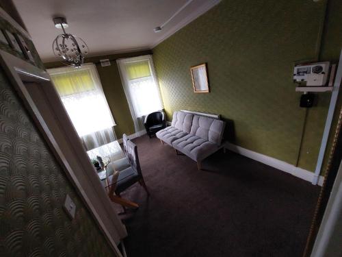 an overhead view of a living room with a couch and chairs at Captivating 1-Bed Apartment in Blackpool in Blackpool