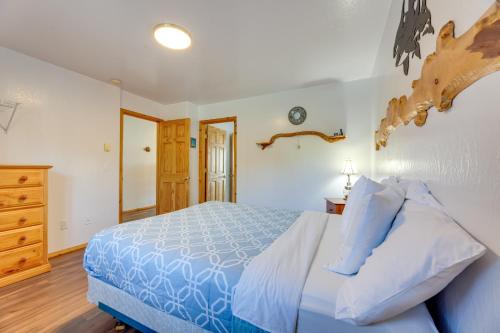 a bedroom with a blue bed and a wooden dresser at Sanderling Sea Cottages, Unit 13 in Waldport
