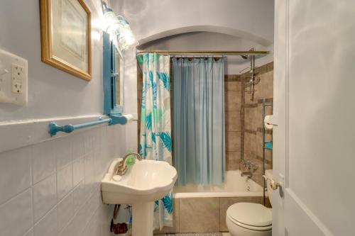 a bathroom with a sink and a toilet and a shower at Detroit Getaway with Fireplace Near Ford Field in Detroit