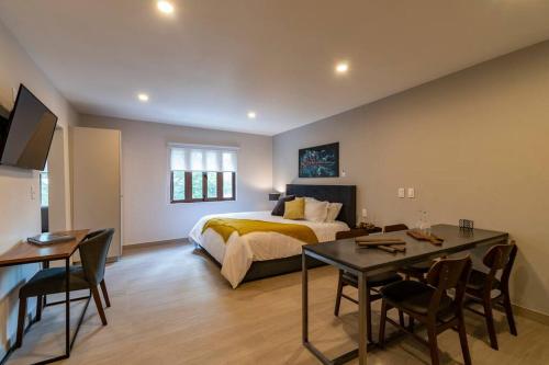 a bedroom with a bed and a table and chairs at LOVELY LOFT IN COYOACÁN (FRIDA) by M&I in Mexico City