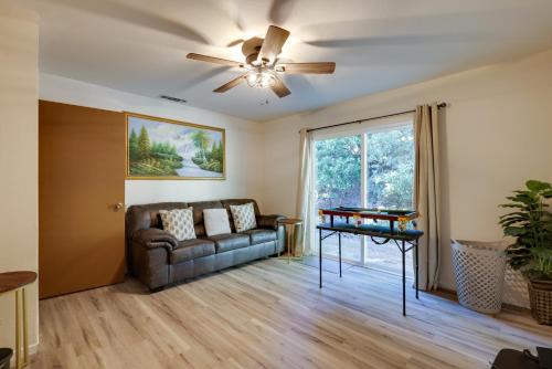 a living room with a couch and a ceiling fan at Furnished Deck and Fire Pit Sherwood Forest Cabin in Twain Harte