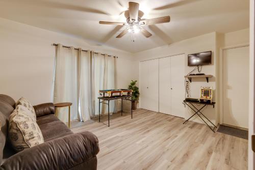 a living room with a couch and a ceiling fan at Furnished Deck and Fire Pit Sherwood Forest Cabin in Twain Harte