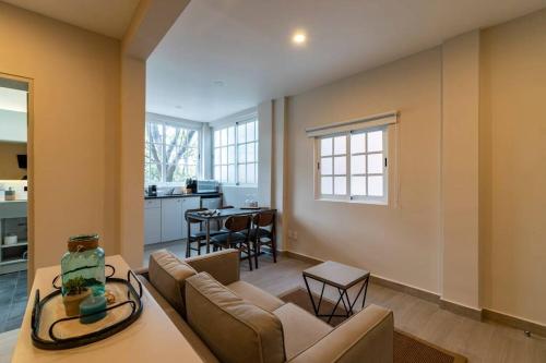 a living room with a couch and a table at LOVELY LOFT COYOACAN (DIEGO) in Mexico City