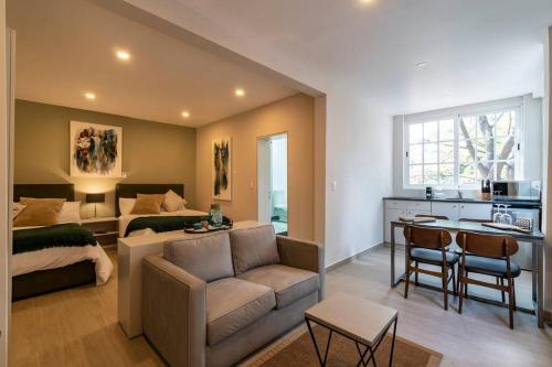 a living room with a couch and a bed and a table at LOVELY LOFT COYOACAN (DIEGO) in Mexico City