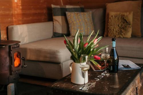 a living room with a couch and a table with wine glasses at Modulog 1 At Tapnell Farm in Yarmouth