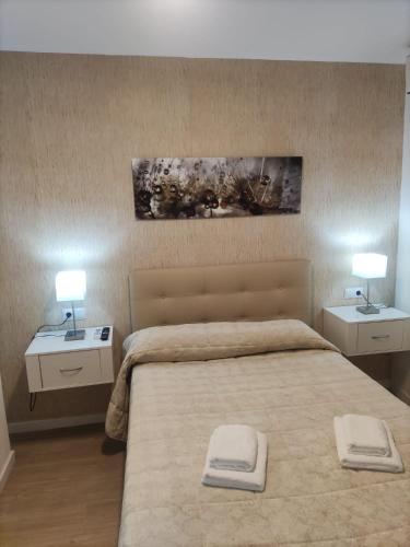 a bedroom with a large bed with two night stands at Apartamento Margari in Ronda