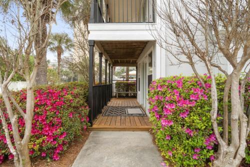 a house with pink flowers in the front yard at Serenity Cottage - Spacious Haven - Private Pool in Destin