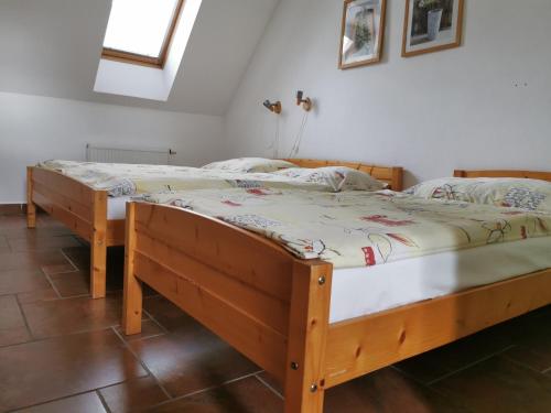 two twin beds in a room with at Penzion Mia in Dolní Moravice