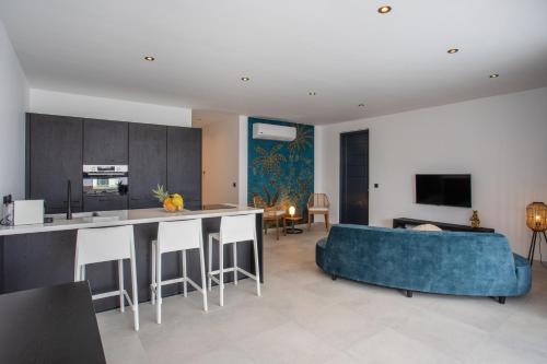 a kitchen and a living room with a blue couch at Oasis luxury apartment in Jan Thiel - close to the beach in Jan Thiel