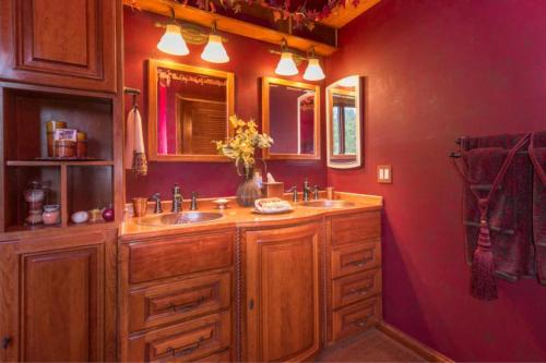 帕索羅布的住宿－Hilltop Round House Sanctuary，浴室设有两个水槽和红色的墙壁