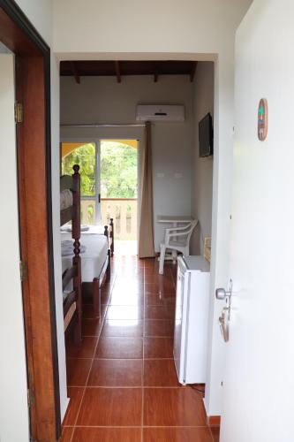 a room with a bedroom with a bed and a window at Camping Pousada Ilha do Mel - Frente ao Mar in Boracéia