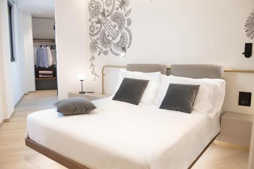 a white bed with two pillows on it in a bedroom at Panorama Hotel Friuli - Boutique Hotel in San Daniele del Friuli