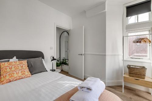a white bedroom with a bed and a window at The Stafford in London