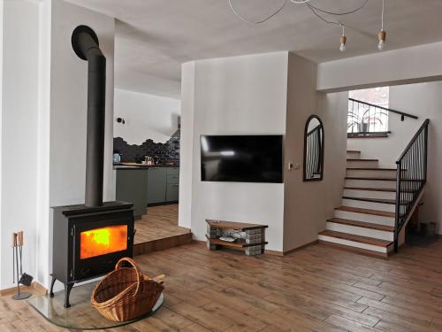 a living room with a fireplace and a staircase at Rodinná Rezidence Žihobce - prázdninový dům in Žihobce